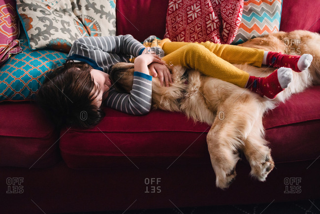 Girl napping with golden retriever