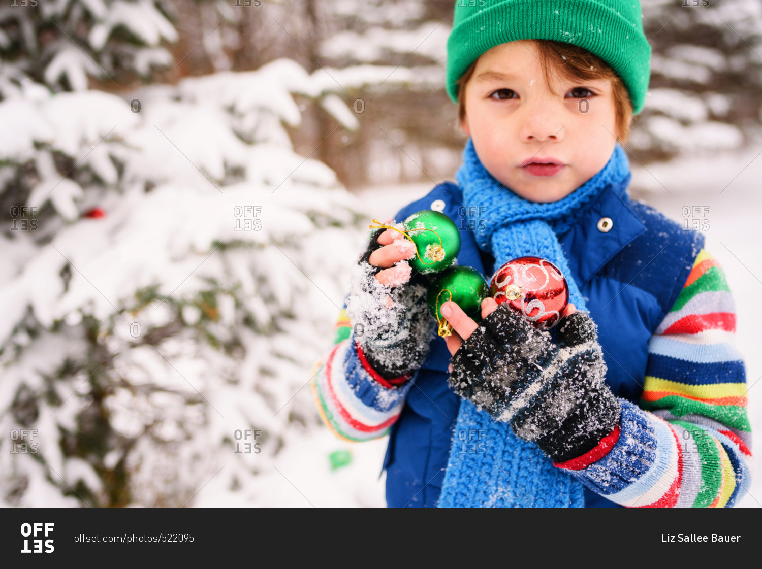 Boy with ornaments in a winter field