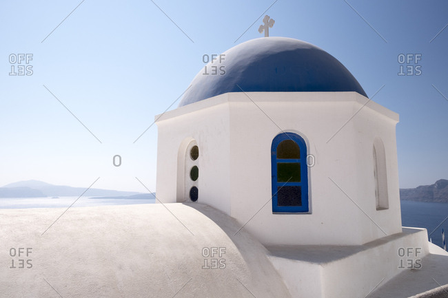 A classic blue dome of a Greek Orthodox church in Santorini, Greece.