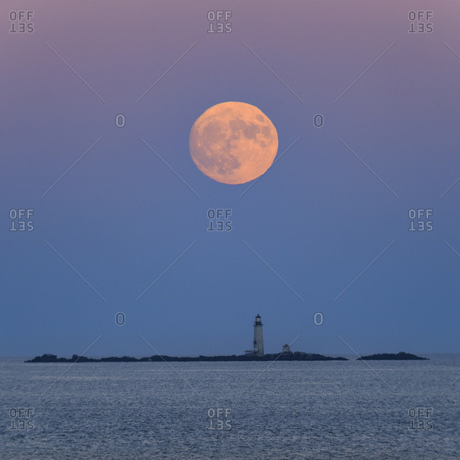 The full moon rising over the Boston Harbor Islands.