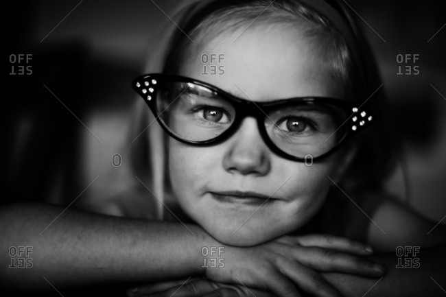 Young girl wearing pair of retro cat eye glasses