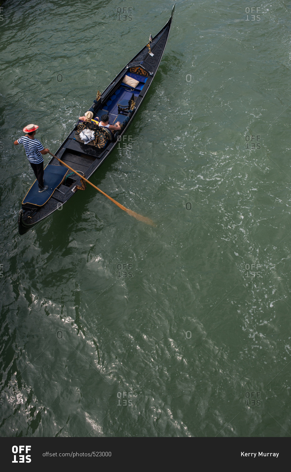 Elevated view of couple taking a gondola tour of Grand Canal in Venice, Italy
