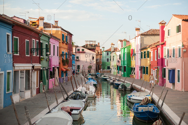 Venice, Italy - July 22, 2015: Colorful houses and boats in a canal in Burano, Venice, Italy