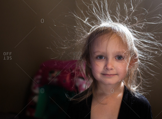 Cute little girl with hair charged with static electricity