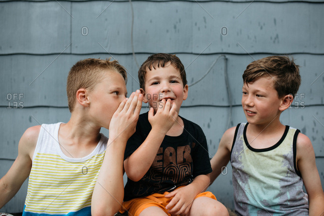 Three boys sharing secrets