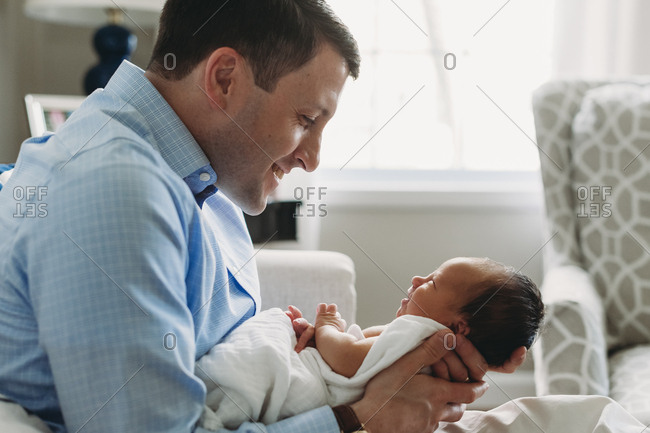 Newborn baby smiles at his father