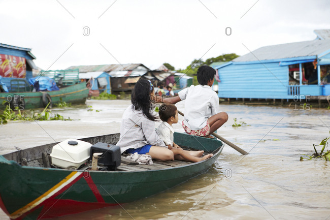 Siem Reap, Cambodia - July 10, 2012: Rear view of a family riding on boat in the Tonle Sap Great Lake in Siem Reap