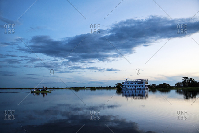 Group of tourists returning to their river boat at dusk on the Amazon