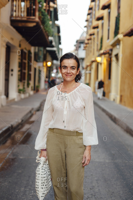 Woman looking at the camera in the main street of the old town of Cartagena de Indias, Colombia