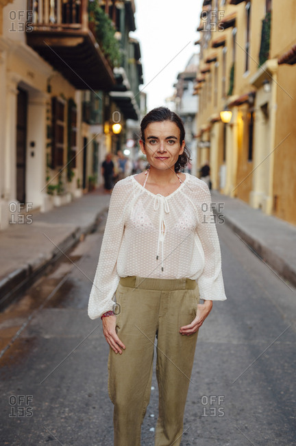 Woman looking at the camera in the main street of the old town of Cartagena de Indias, Colombia