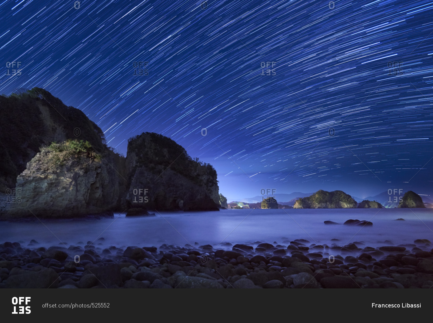 Star trails at night over sea and rock formations at Futo coast, Shizuoka Prefecture, Japan