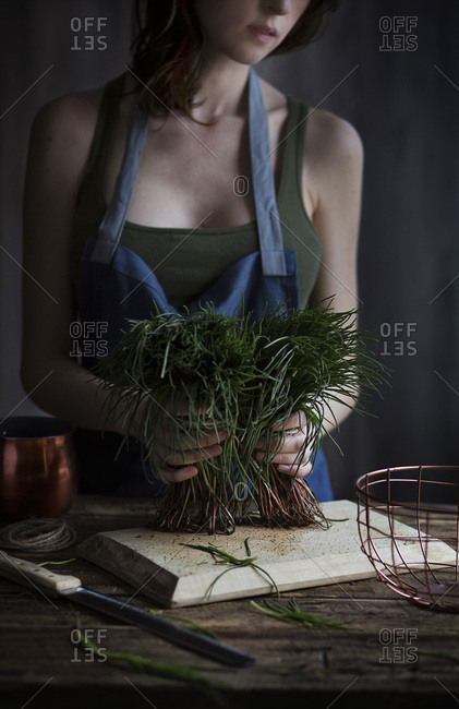 Woman holding agretti, a typical italian spring vegetables