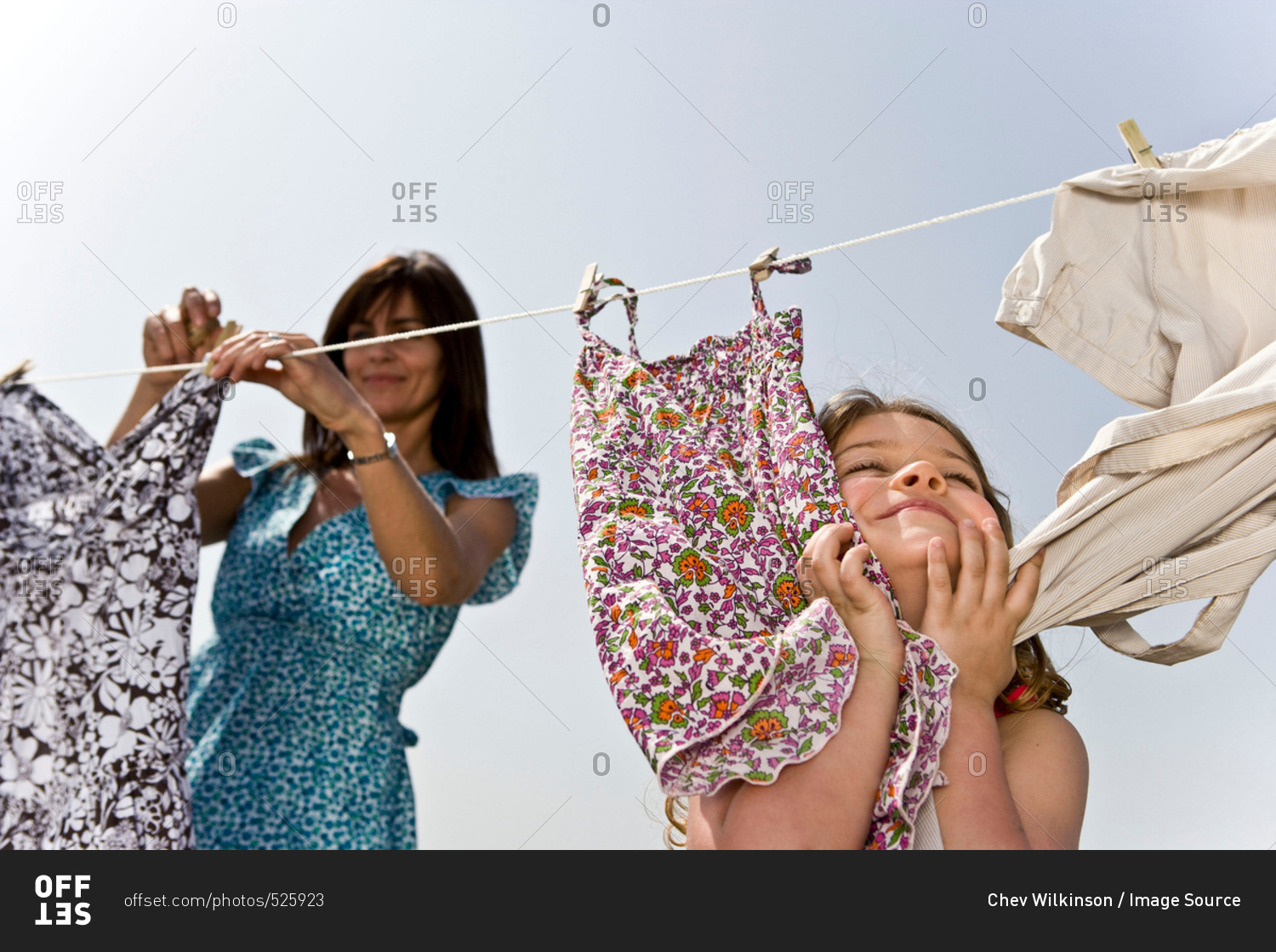 Girl rubbing clothes on face stock photo OFFSET