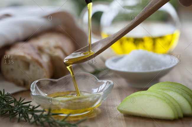 Pouring olive oil onto a spoon