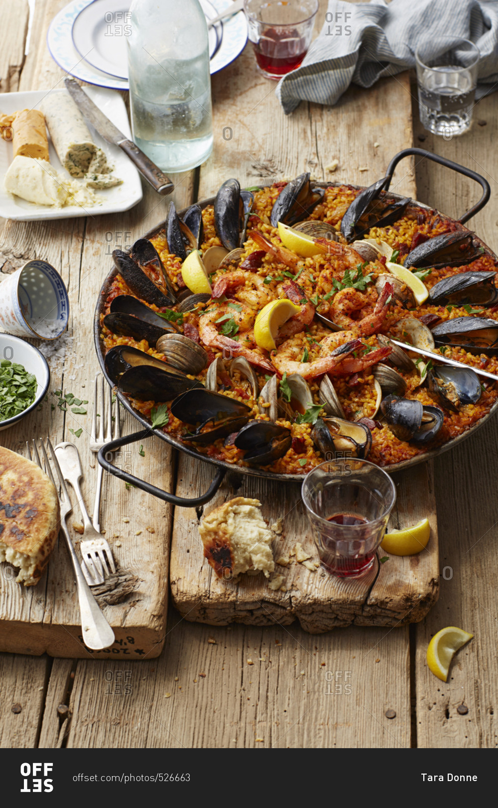 Seafood Paella on a rustic wood table stock photo - OFFSET