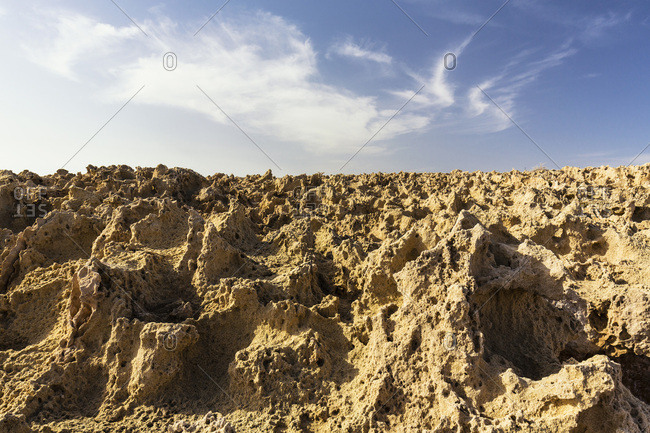 Eroded rock surface by the coast agianst the sky, low angle perspective, Cape Greco, National Forest Park, Agia Napa, Cyprus