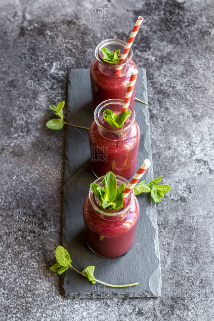 Beet root smoothie in glasses garnished with fresh mint