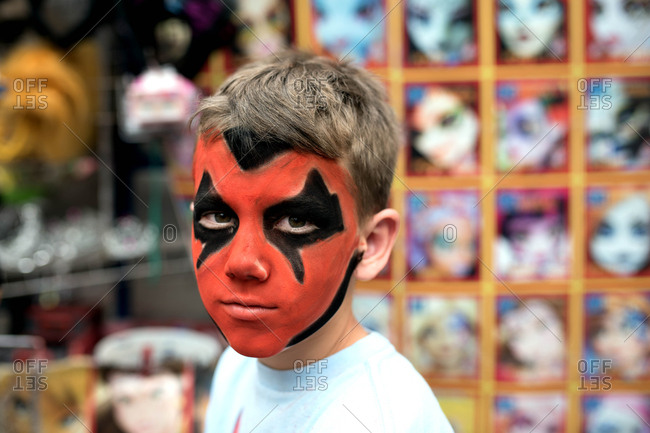 Boy with red and black face paint stock photo - OFFSET
