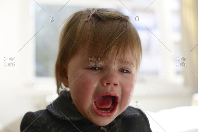 Young girl crying passionately