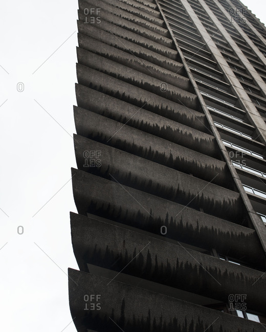 A dark concrete building with balconies