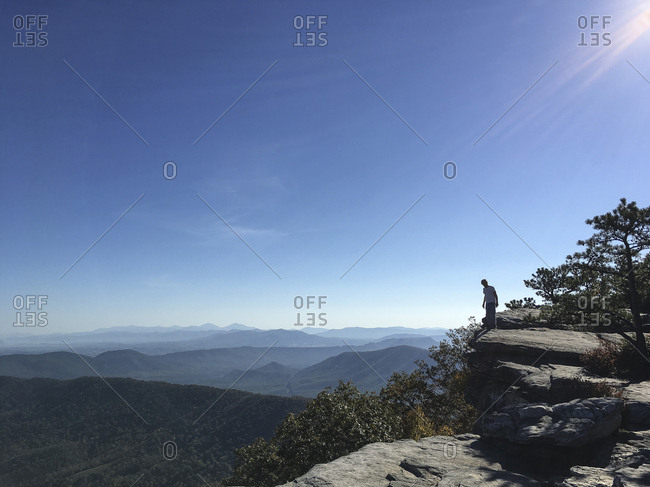 Man standing on edge of cliff
