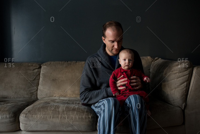 Dad balancing baby on his leg