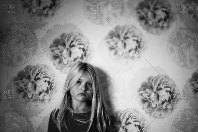 Girl against floral wallpaper - from the Offset Collection