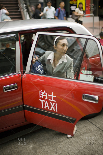 Businesswoman exiting a taxi