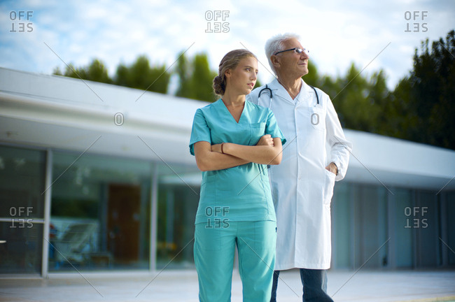 Doctor and nurse standing outside a medical building