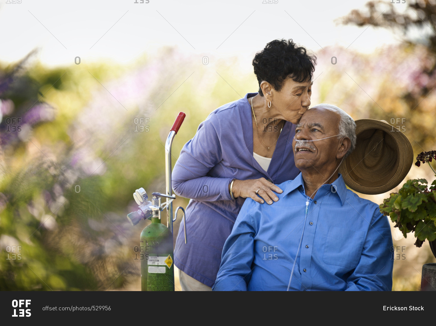 Senior couple with breathing apparatus spending time in their garden
