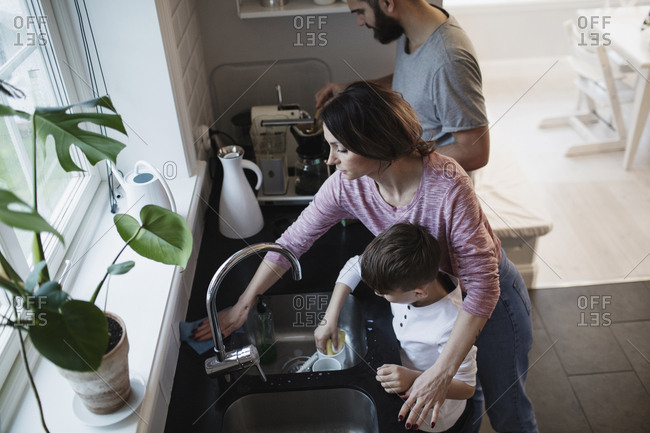 man cleaning kitchen counter stock photos - OFFSET