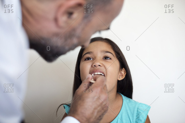 Doctor examining girl in medical examination room