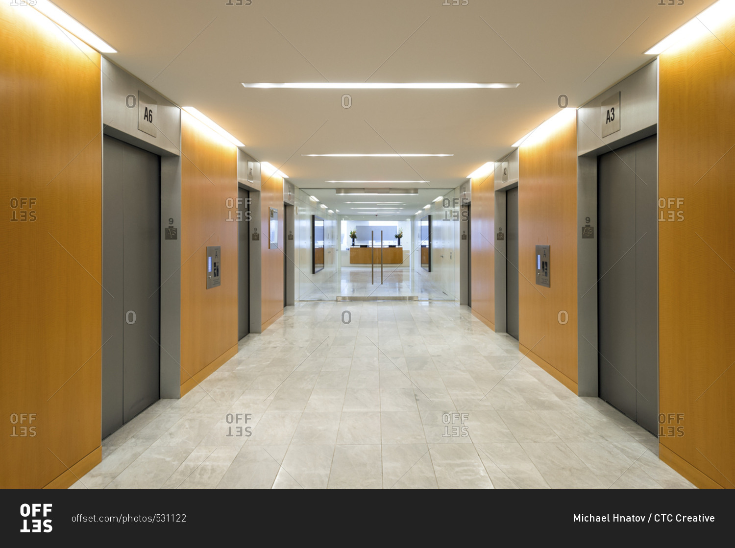 Mirror image of elevators - Offset stock photo - OFFSET