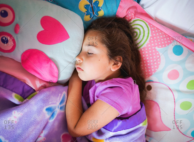 Young girl sleeping with owl pillow