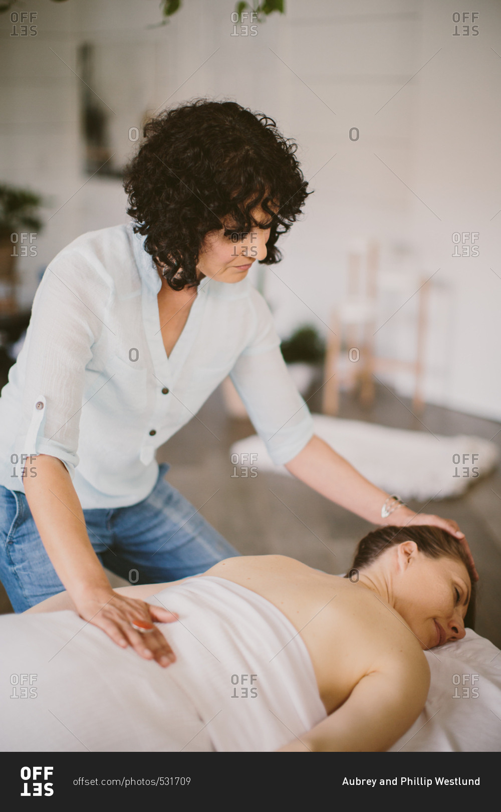 Woman on a massage table with masseuse