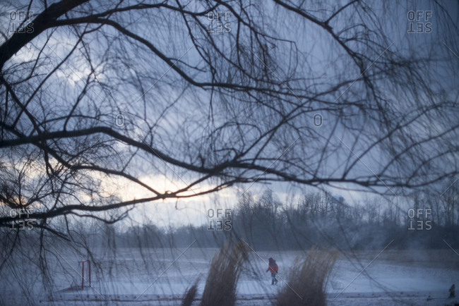 Child skating on a homemade ice rink