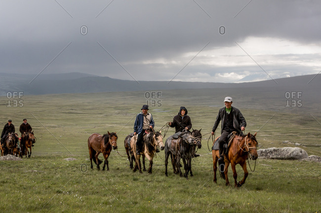 Altai Mountains, Mongolia - July 11, 2016: Kazakh men riding on horses