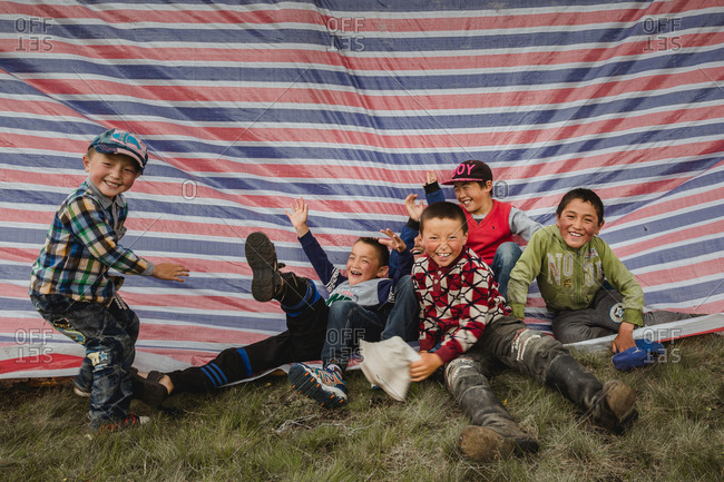 Altai Mountains, Mongolia - July 12, 2016: Kazakh kids playing on fabric