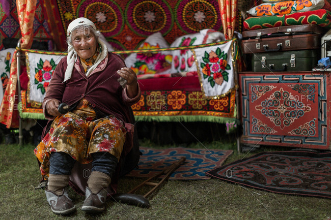 Altai Mountains, Mongolia - July 15, 2016: Old Kazakh woman in traditional shelter