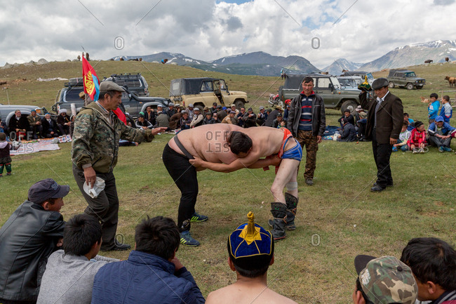 Altai Mountains, Mongolia - July 18, 2016: Two men wrestling at a wedding