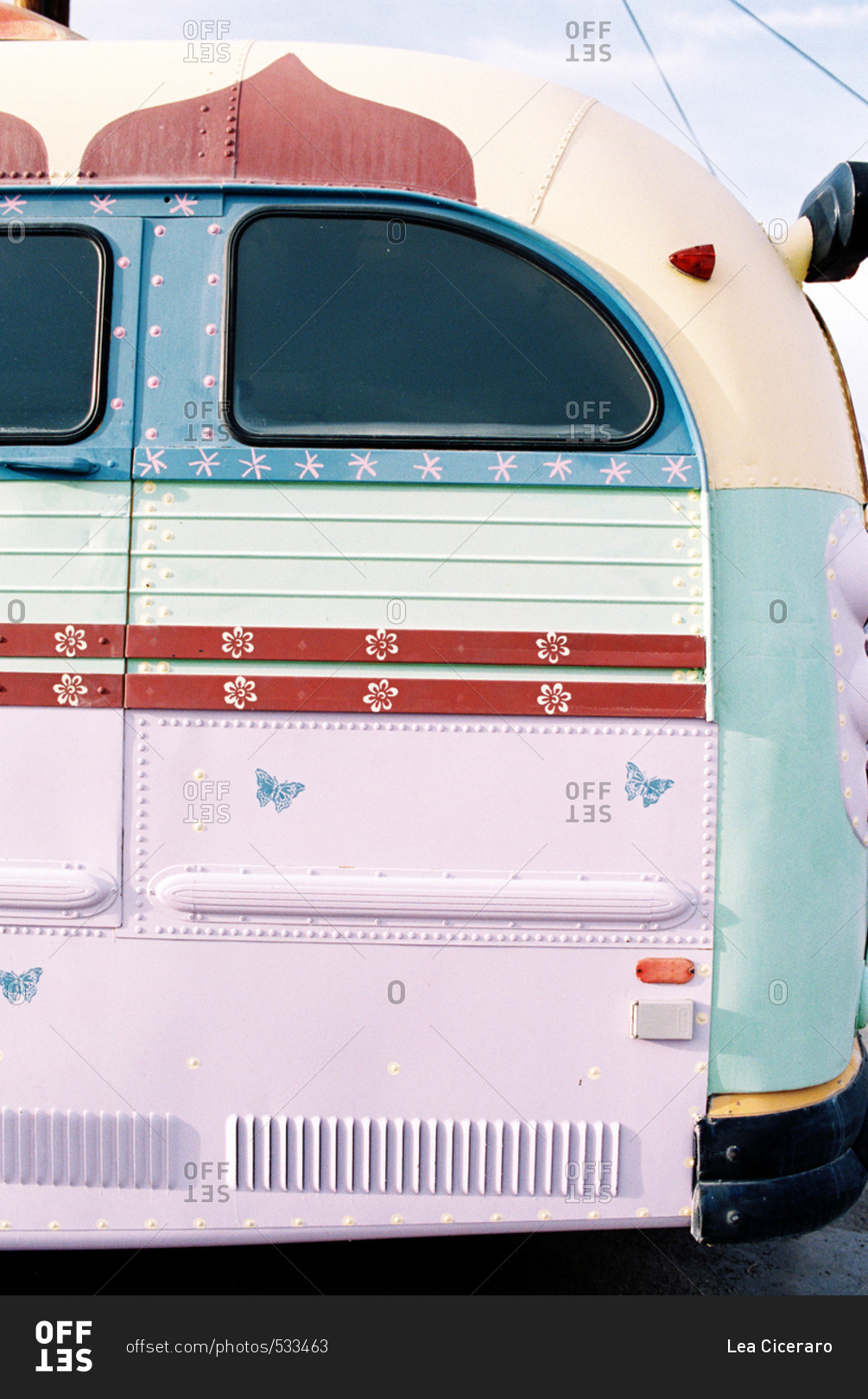 Details of a brightly painted hippy bus with butterfly and flower decals