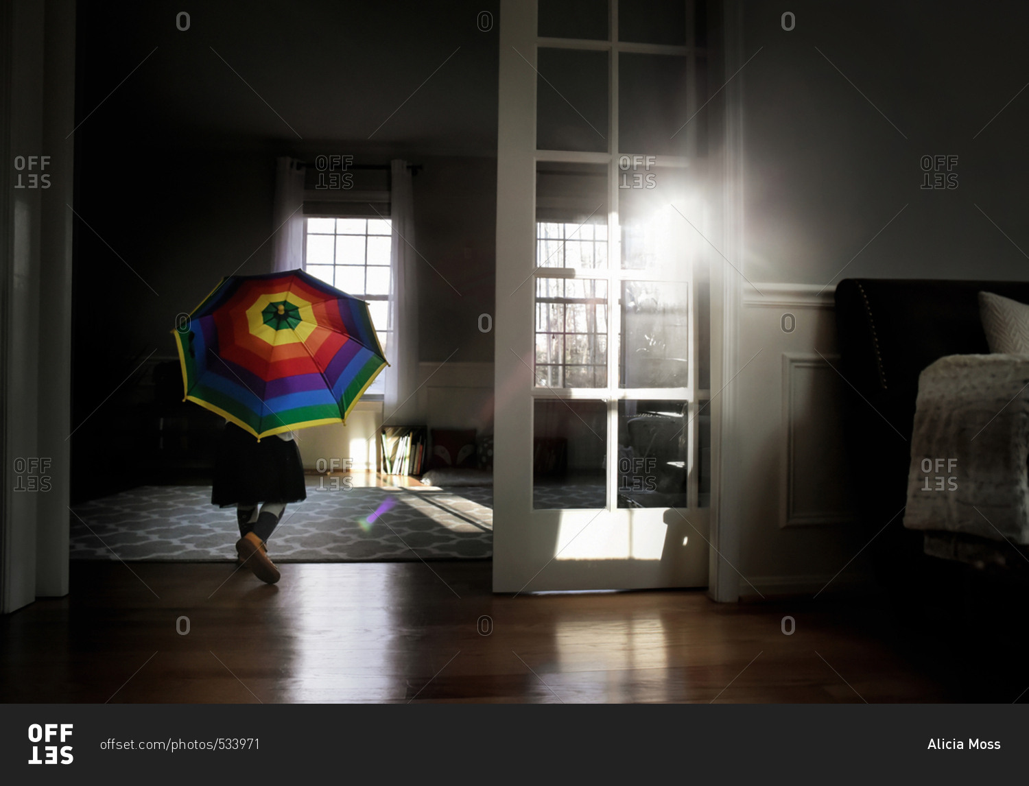 Girl running indoors with umbrella