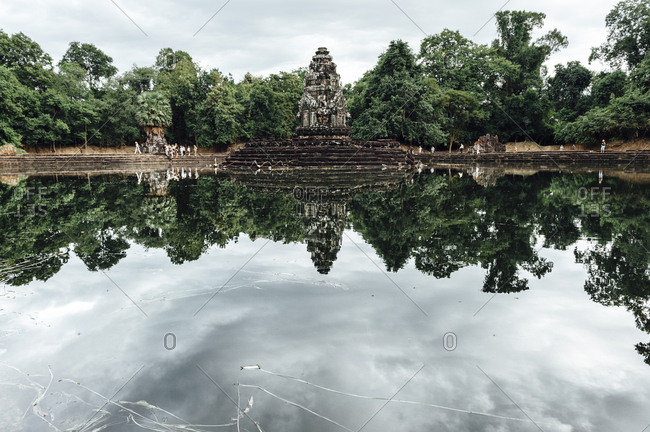 View of Angkor Wat temple reflected in the water in Laos