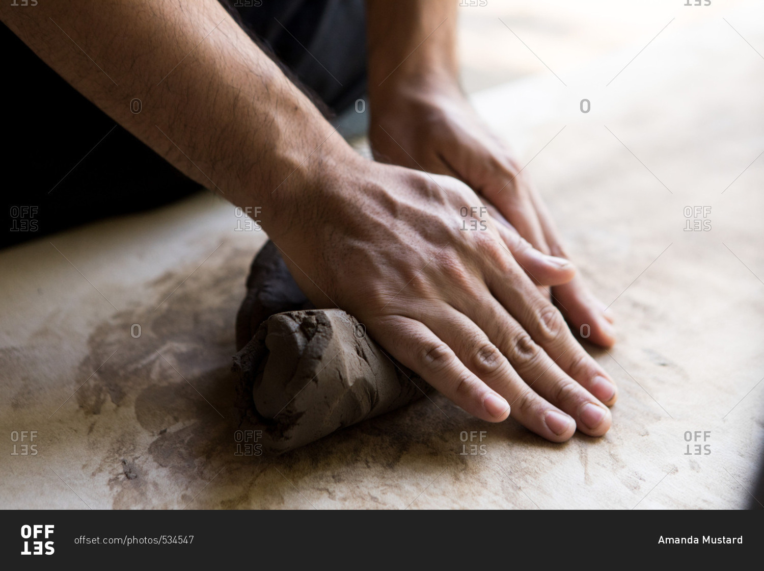 Hands molding clay in a pottery and ceramic studio in Chiang Mai, Thailand  stock photo - OFFSET