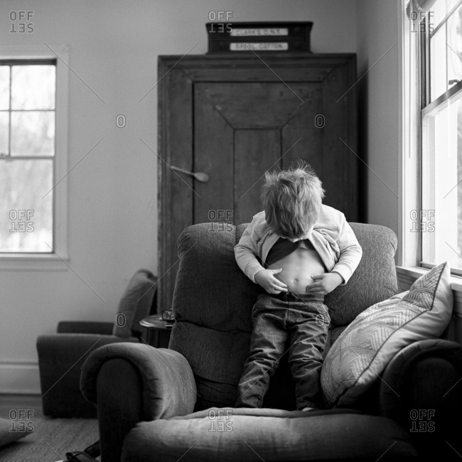 Boy looking at his belly button