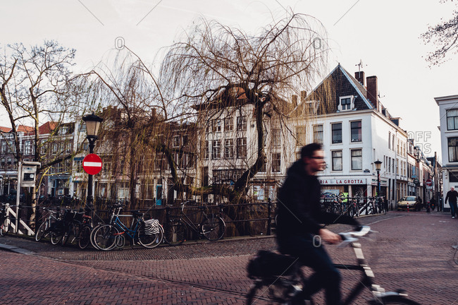 Utrecht, Netherlands - February 14, 2014: Blurry man on bike in Dutch town