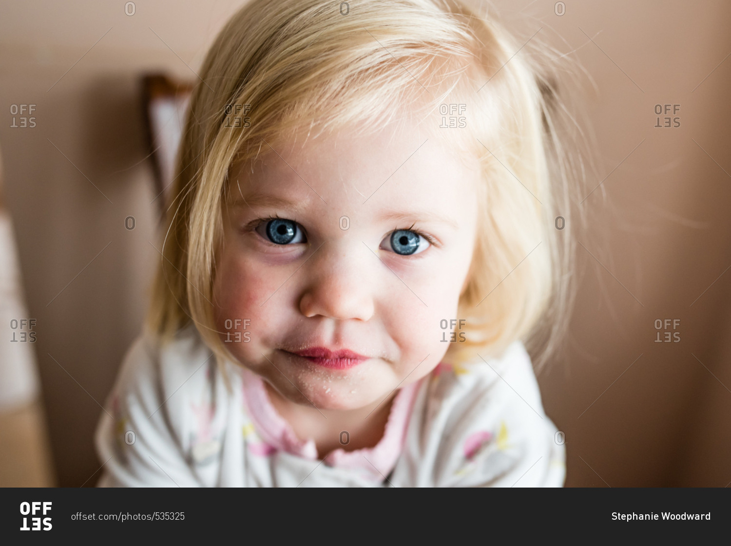 Close up of a toddler girl with blonde hair and blue eyes stock photo -  OFFSET