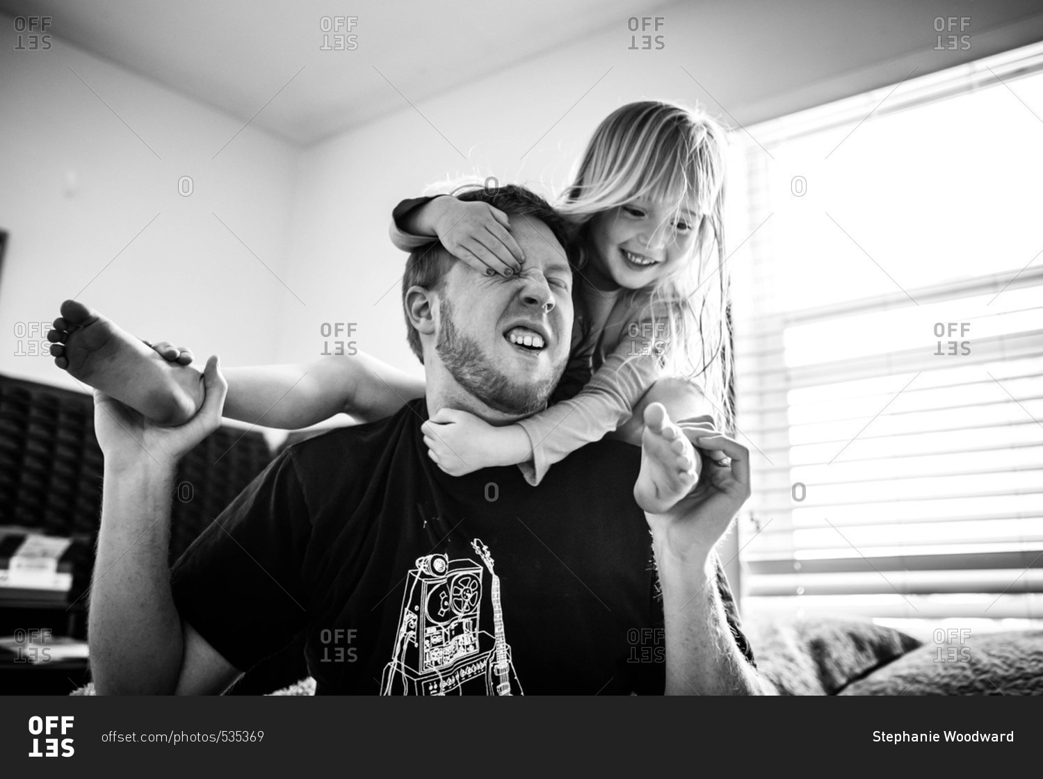 Little girl wrestling with her dad