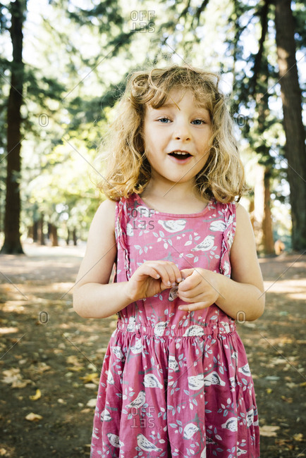 Portrait of smiling Caucasian girl near trees