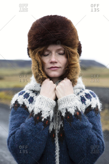 Caucasian woman wearing sweater and fur hat